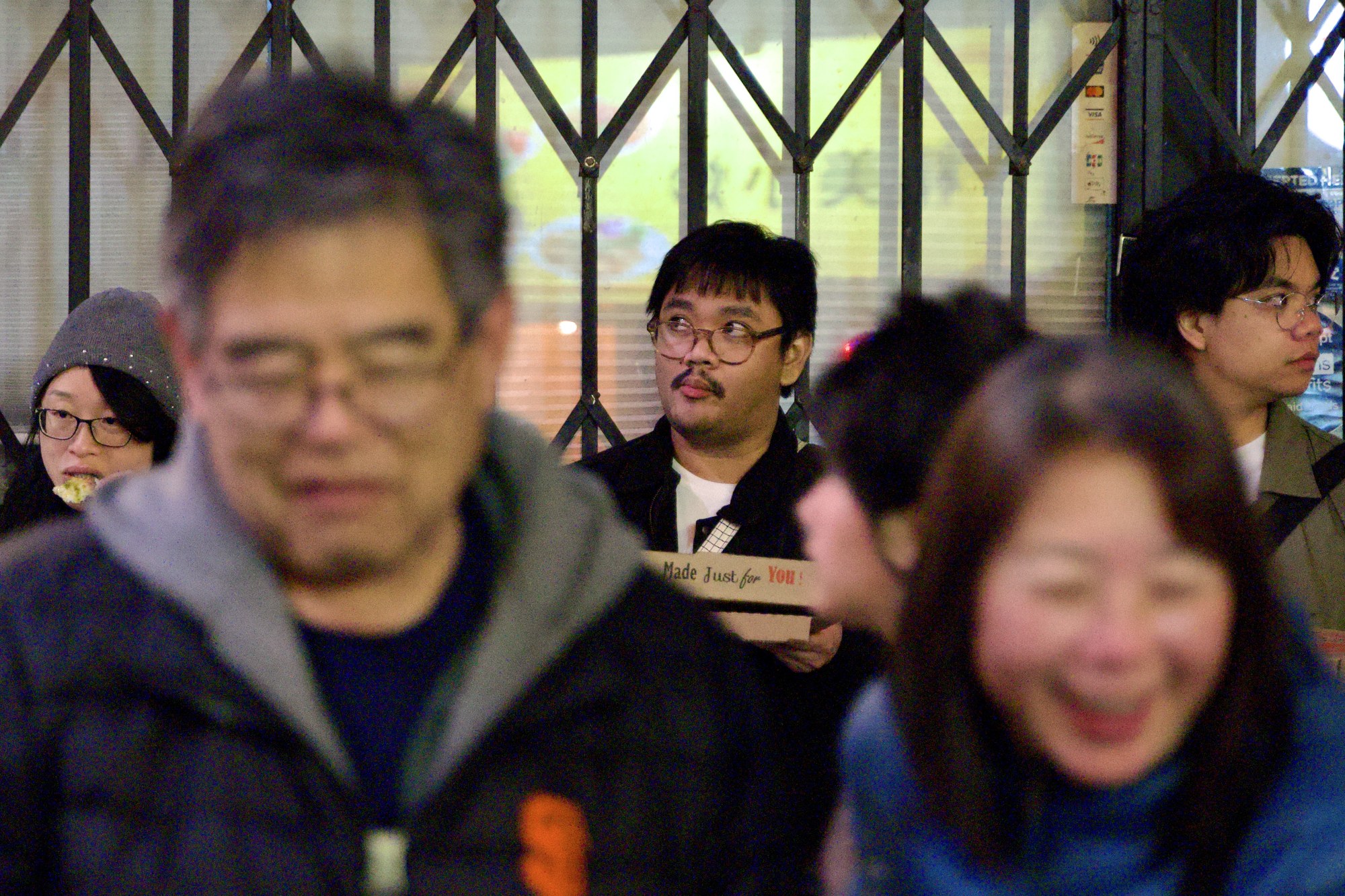 People gathered by a metal gate