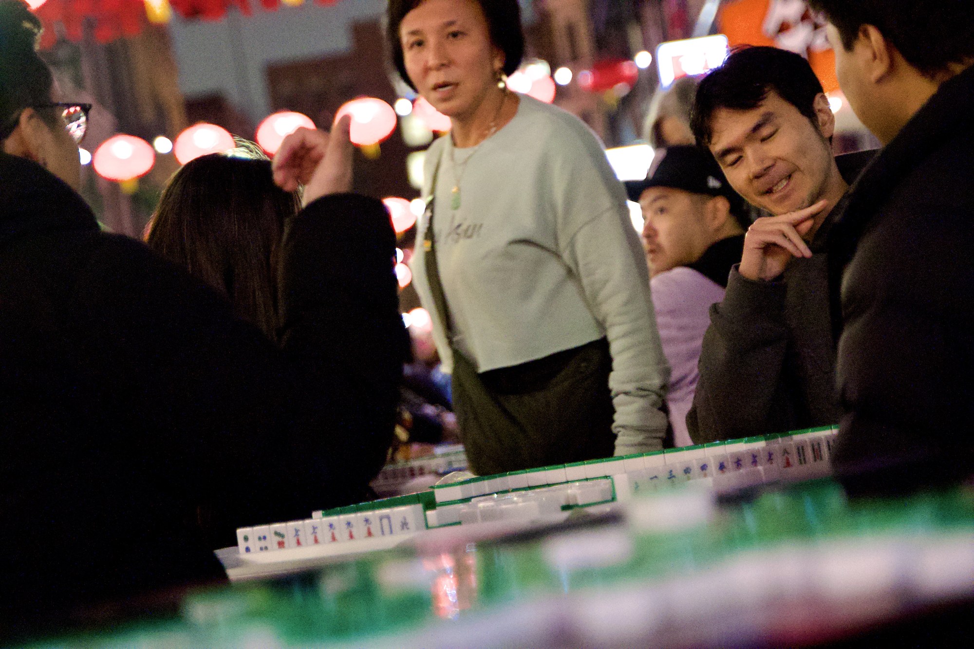 Players gathered around a mahjong table