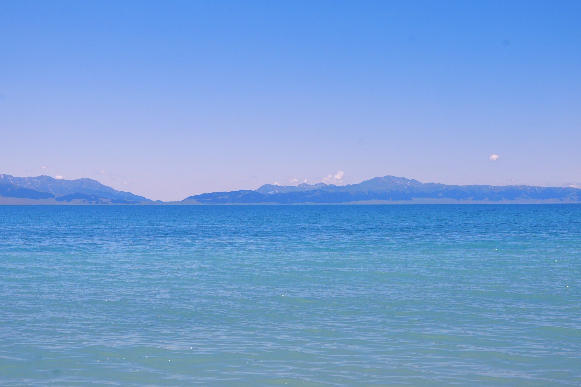 An open lake beneath a blue sky