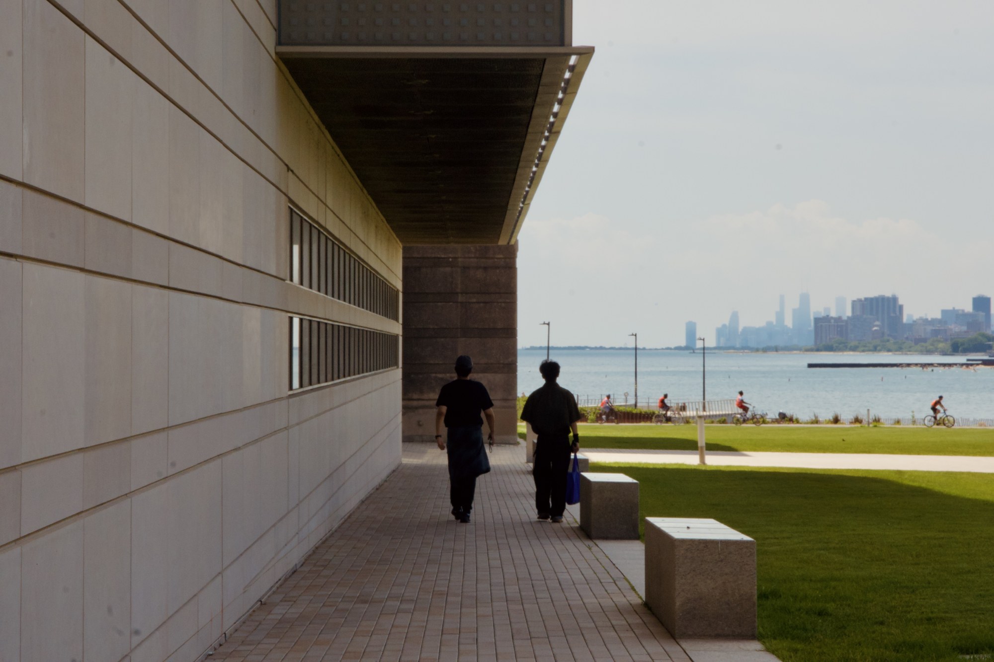 Two figures beneath a covered walkway
