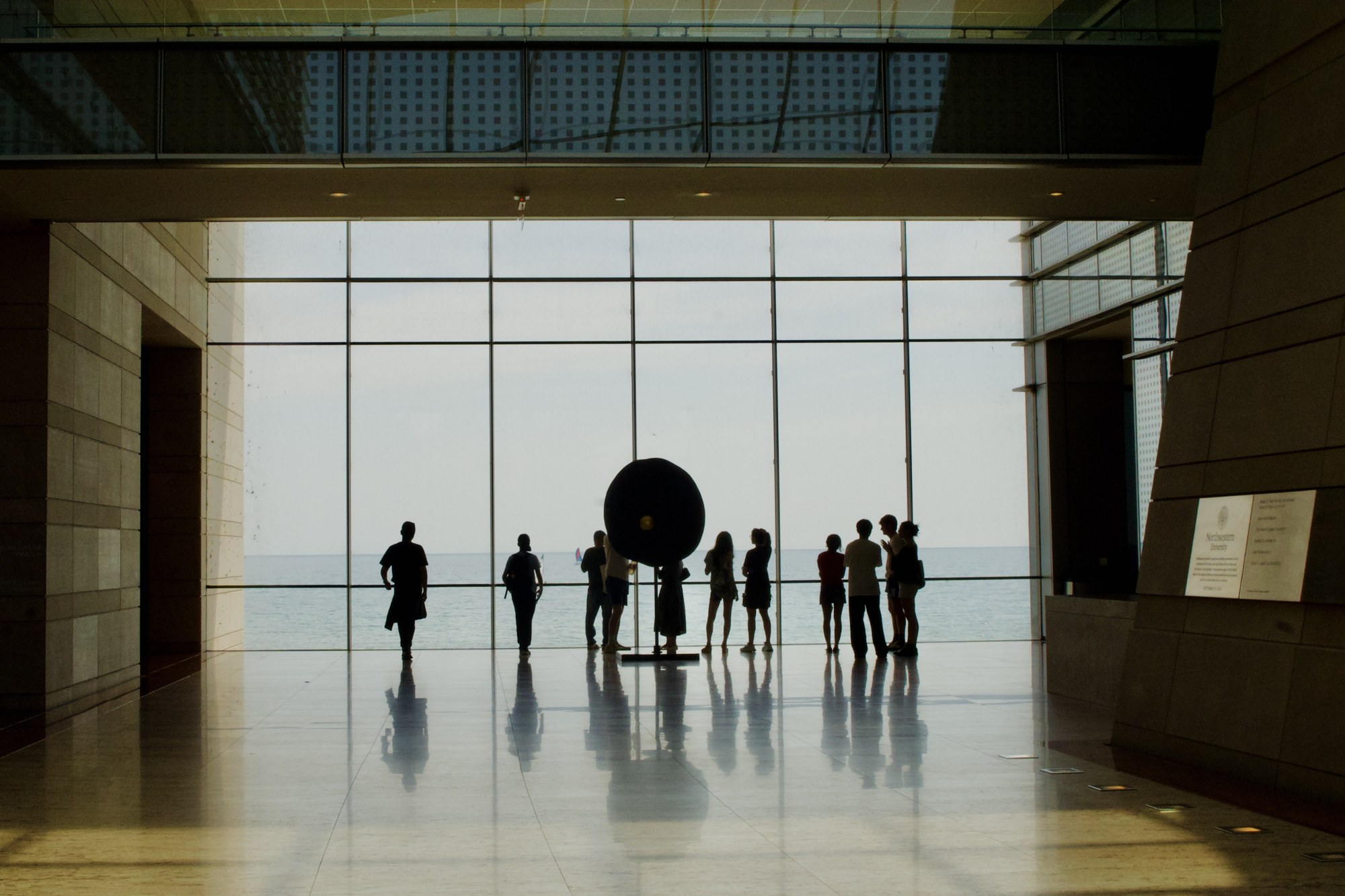 Visitors silhouetted in a large interior