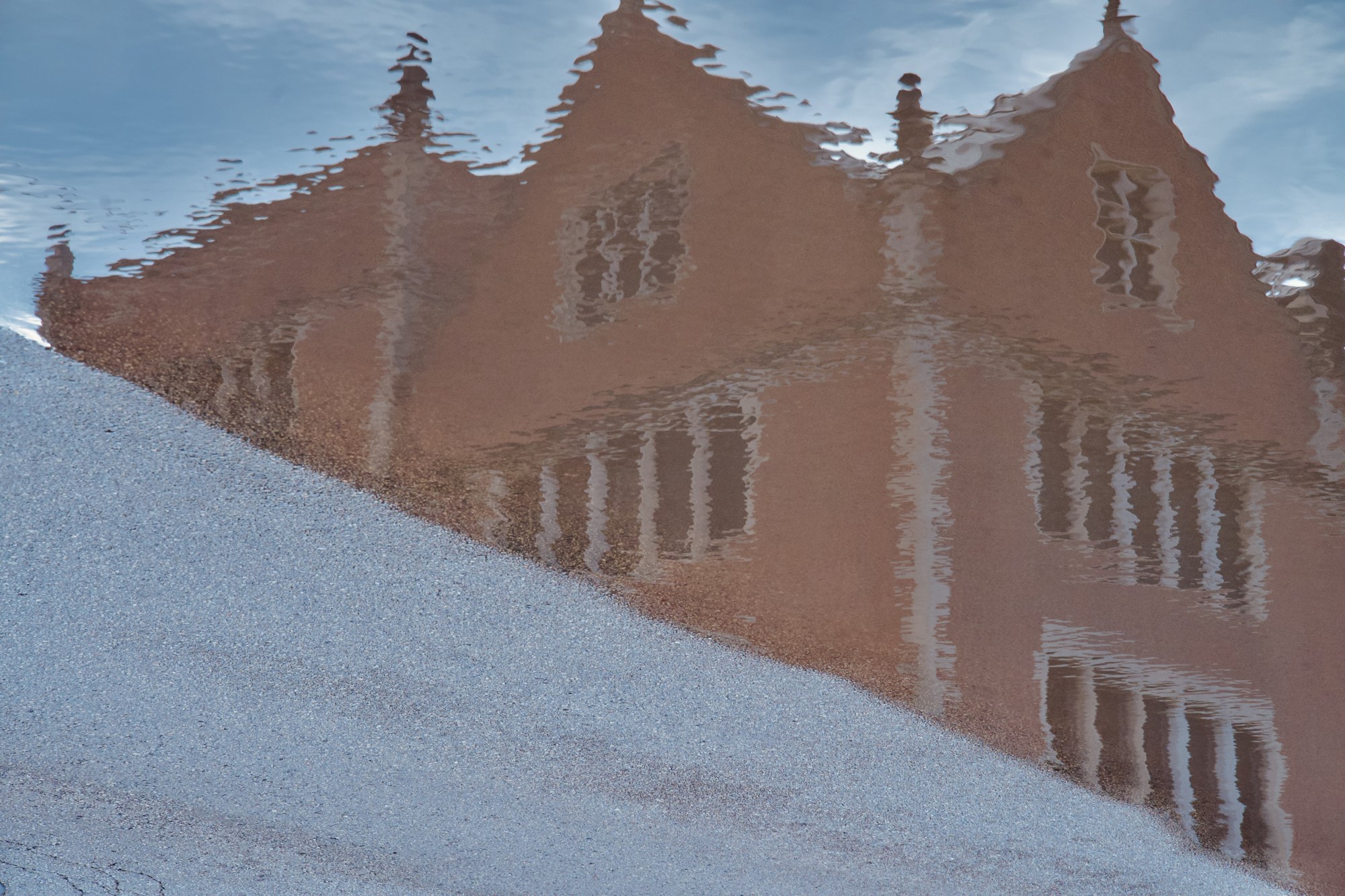 A reflection of a brick building