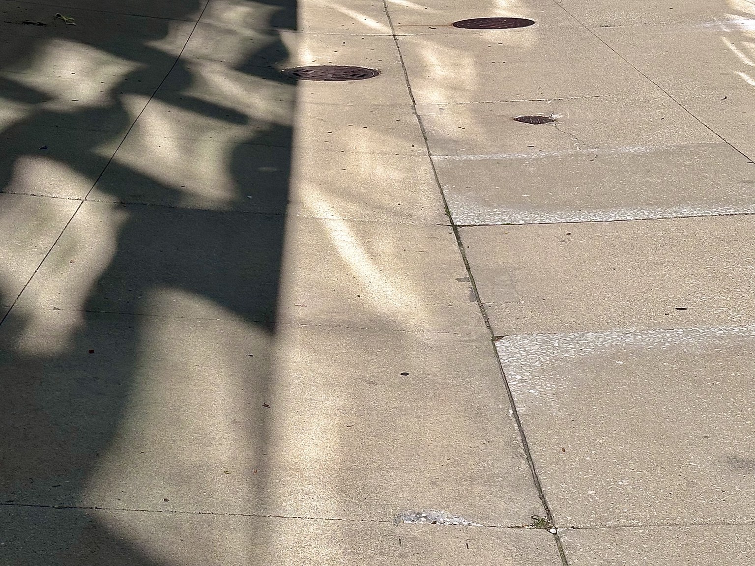 Geometric shadows crossing paving stones