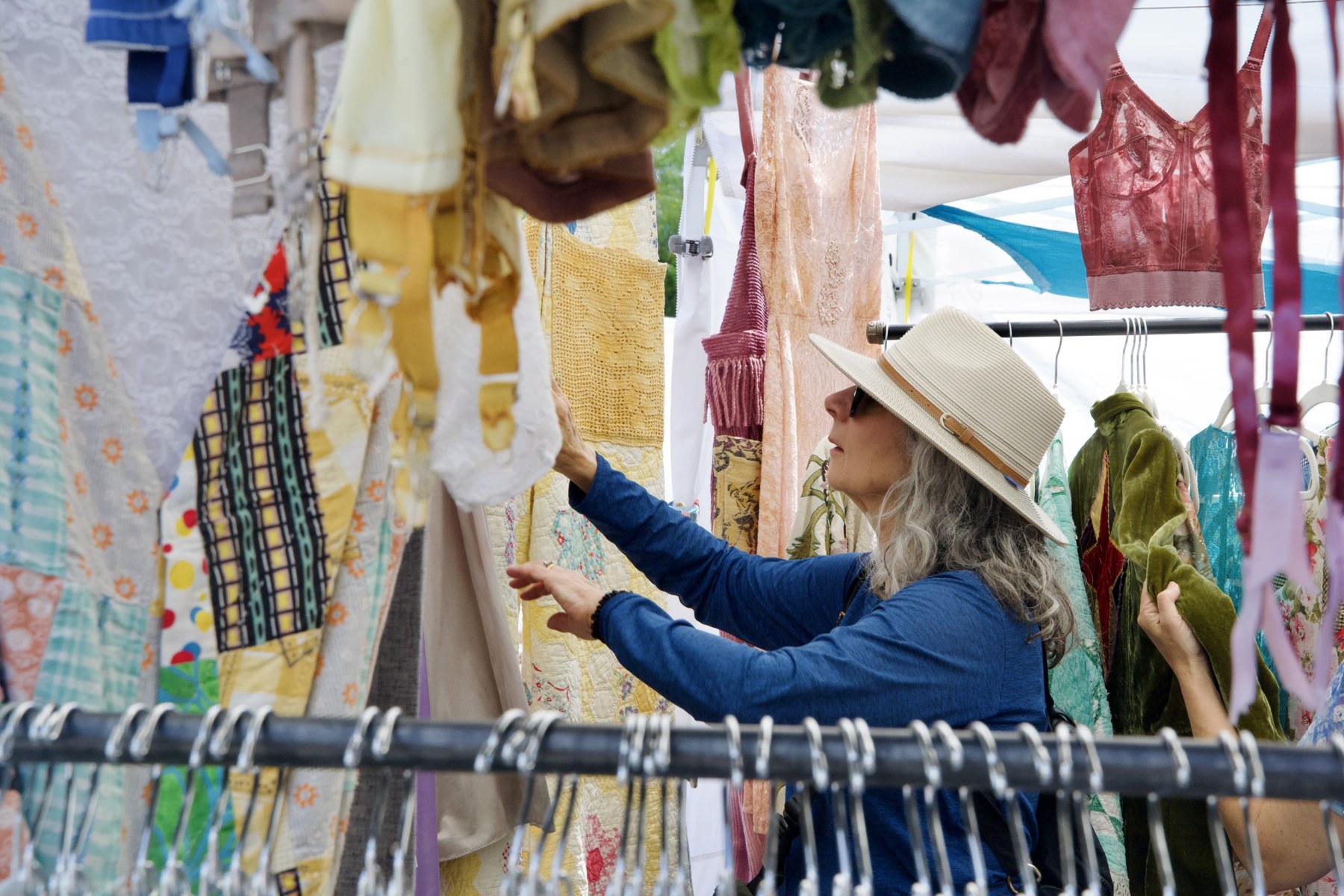 Marla Abramson takes time perusing vintage clothing pieces from Stephanie Nugent, owner of indyvin.