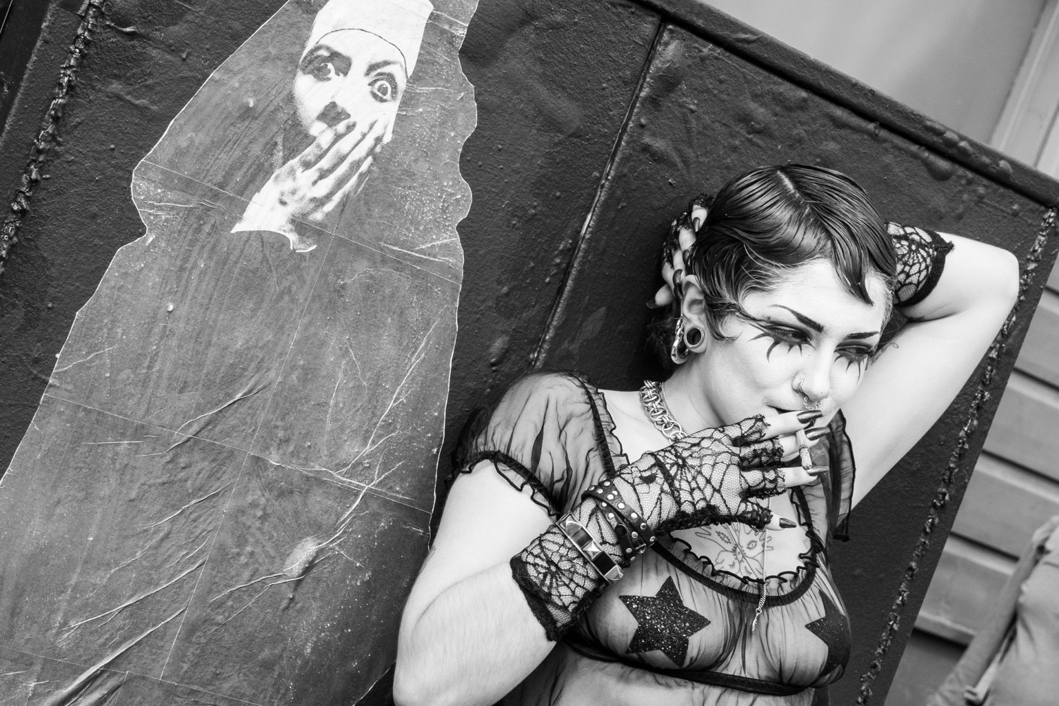 A fairgoer poses beside a painted figure at the 43rd annual Folsom Street Fair in San Francisco on Sept. 27, 2026.