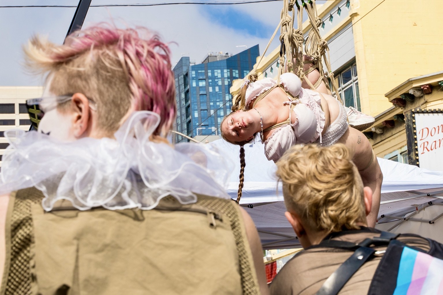 Fairgoers watch a performance above the crowd at the 43rd annual Folsom Street Fair in San Francisco on Sept. 27, 2026.