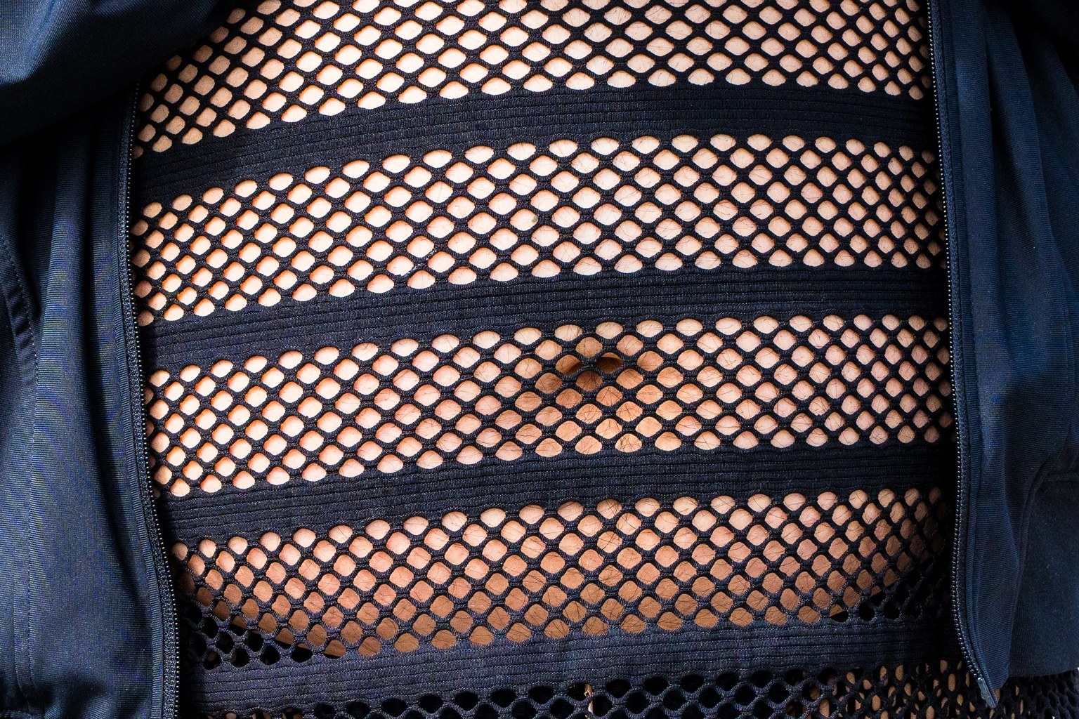 Mesh and leather straps form part of a fairgoer’s outfit at the 43rd annual Folsom Street Fair in San Francisco on Sept. 27, 2026.