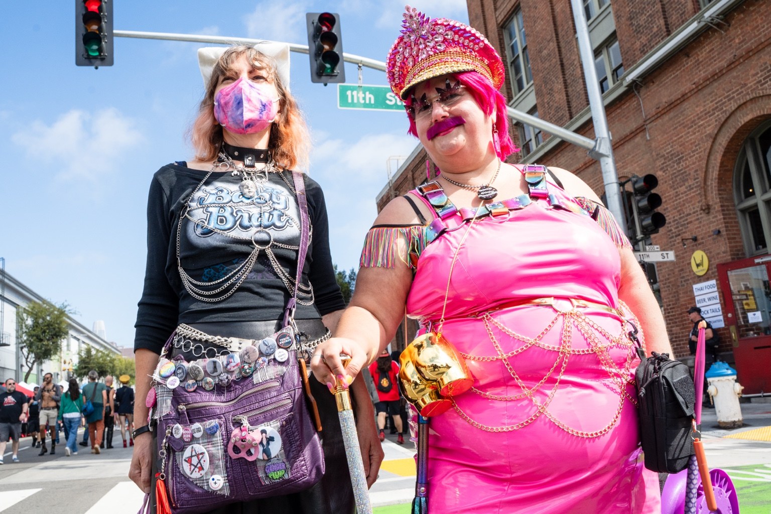 Two fairgoers pose in colorful outfits at the 43rd annual Folsom Street Fair in San Francisco on Sept. 27, 2026.