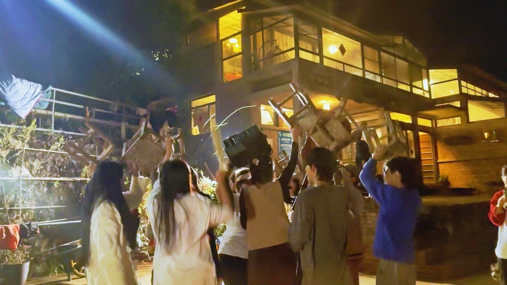 On Karaoke nights, when the music switched from a 2010s American Pop to a Jingpo "Munaozongge" song, the group grabs the closest objects to them and dance with the rhythms. "Munaozongge" is the biggest primitive ritual here and was danced before battle or to pray for rain in ancient times.